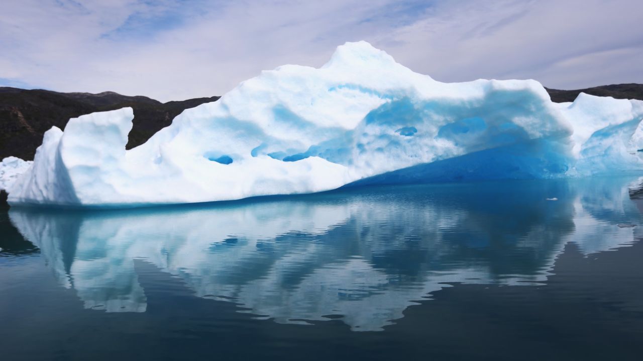 Calved icebergs from the nearby Twin Glaciers are seen floating on the water on July 30, 2013, in Qaqortoq, Greenland.