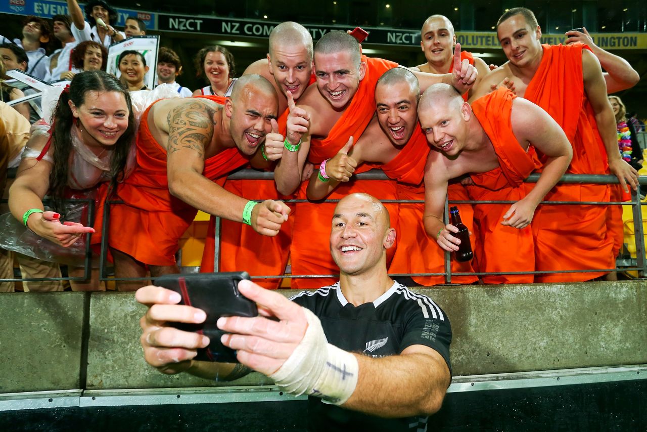 New Zealand captain D.J. Forbes celebrates with fans dressed as the Dalai Lama after his team won the final of the Wellington Sevens in February 2014. 