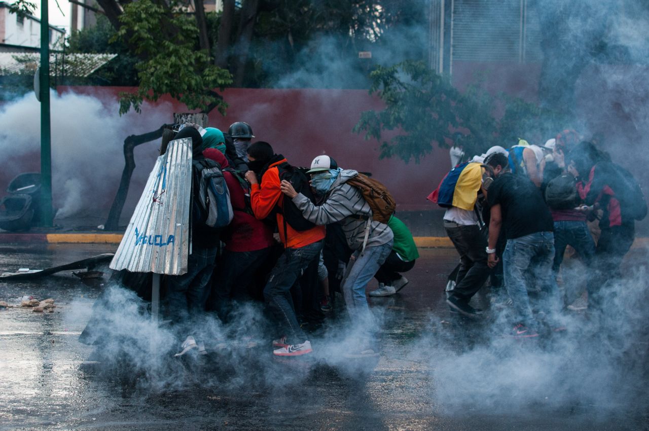 Protesters clash with police forces in Caracas on March 1.