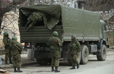 Heavily armed soldiers displaying no identifying insignia maintain watch in Simferopol on March 1.