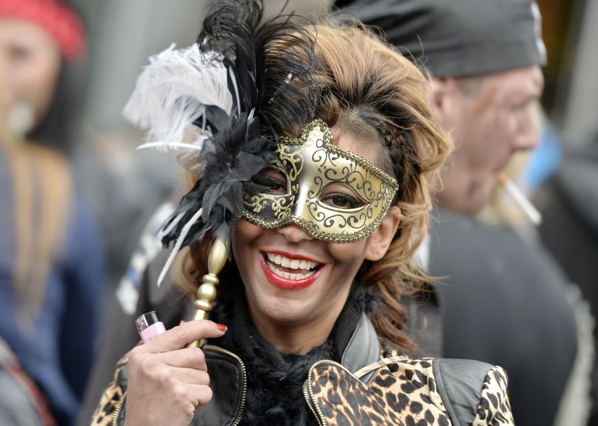 A woman joins tens of thousands of revelers to celebrate the start of a street carnival in Cologne on Thursday, February 27. 