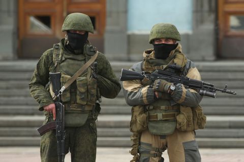 Heavily armed troops, displaying no identifying insignia and who were mingling with local pro-Russian militants, stand guard outside a local government building in Simferopol on March 2. 
