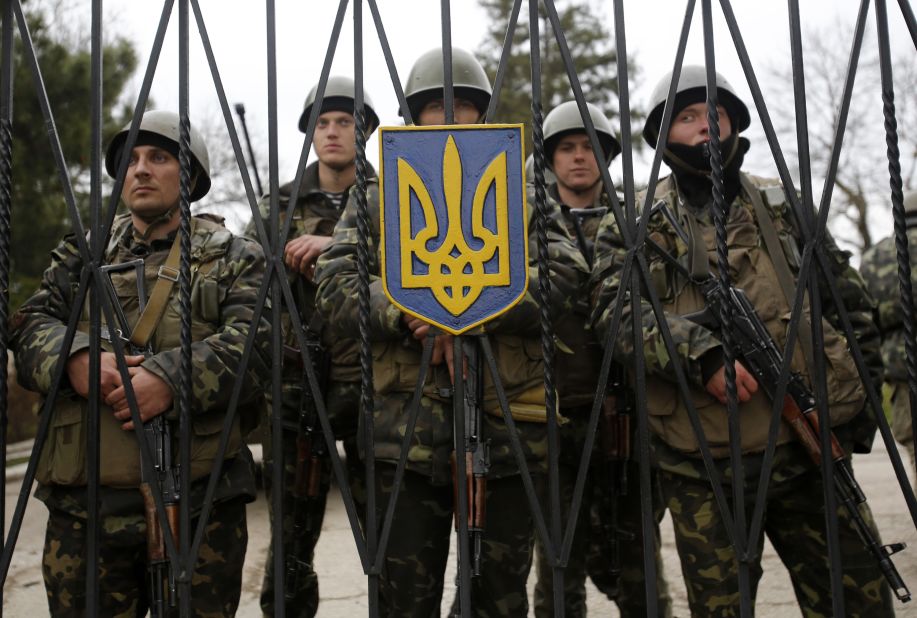 Ukrainian soldiers guard a gate of an infantry base in Perevalne on March 2.