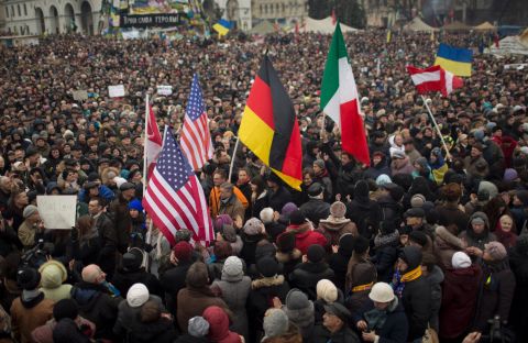 Protesters hold flags of the United States, Germany and Italy during a rally in Independence Square on March 2.