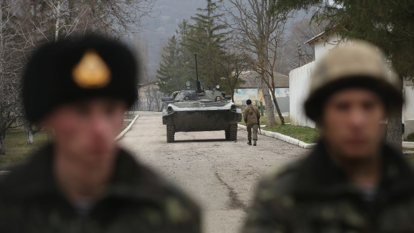 A Ukrainian army tank withdraws from standing just inside the gate with Ukrainian soldiers at a Ukrainian military base that was surrounded by several hundred Russian-speaking soldiers in Crimea on March 2, 2014 in Perevanie, Ukraine. Several hundred heavily-armed soldiers not displaying any idenifying insignia took up positions outside the base and parked several dozen vehicles, mostly trucks and patrol cars, nearby. The new government of Ukraine has appealed to the United Nations Security Council for help against growing Russian intervention in Crimea, where thousands of Russian troops reportedly arrived in recent days at Russian military bases there and also occupy key government and other installations. World leaders are scrambling to persuade Russian President Vladimir Putin to refrain from further escalation in Ukraine. Ukraine has put its armed forces on combat alert. 