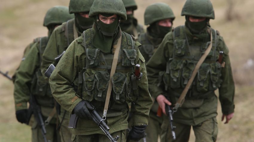 Soldiers who were among several hundred that took up positions around a Ukrainian military base walk on the base's periphery in Crimea on March 2, 2014 in Perevanie, Ukraine. Several hundred heavily-armed soldiers not displaying any idenifying insignia took up positions outside the base and parked several dozen vehicles, mostly trucks and patrol cars, nearby. The new government of Ukraine has appealed to the United Nations Security Council for help against growing Russian intervention in Crimea, where thousands of Russian troops reportedly arrived in recent days at Russian military bases there and also occupy key government and other installations. World leaders are scrambling to persuade Russian President Vladimir Putin to refrain from further escalation in Ukraine. Ukraine has put its armed forces on combat alert. 