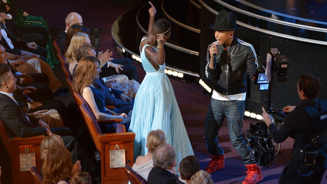 Nyong'o dances with Pharrell Williams during his performance of "Happy."