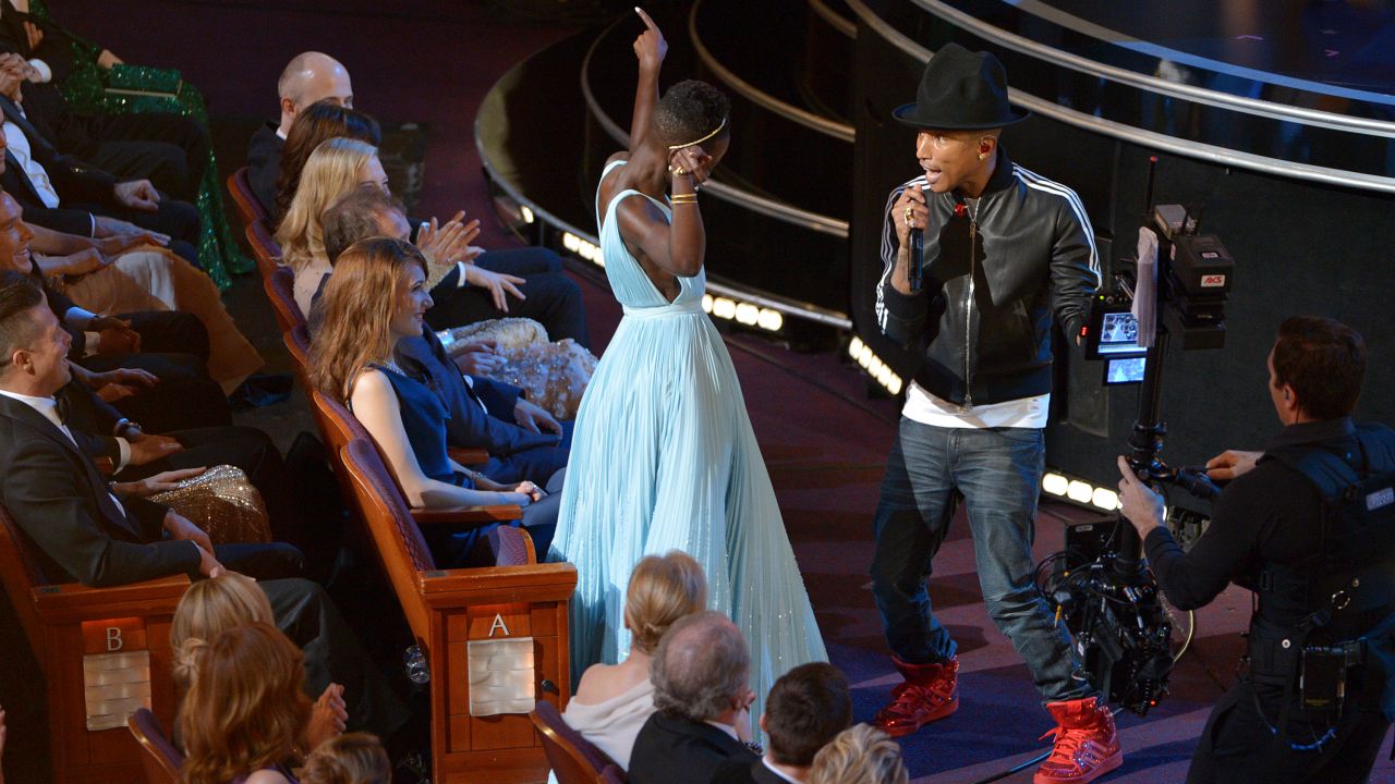 Nyong'o dances with Pharrell Williams during his performance of "Happy."