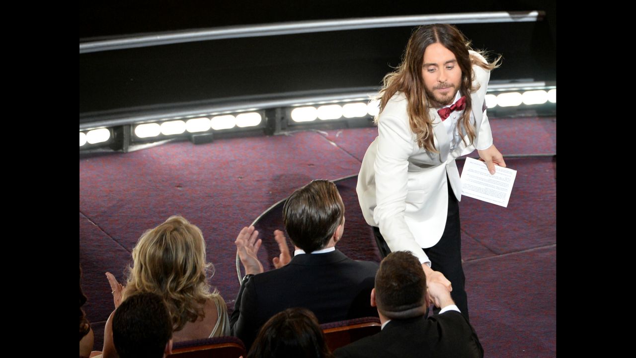Jared Leto shakes hands with an audience member after winning the best supporting actor Oscar for his role in "Dallas Buyers Club."