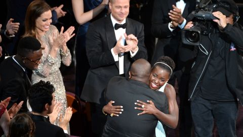 Nyong'o hugs "12 Years a Slave" director Steve McQueen after winning the best supporting actress Oscar.