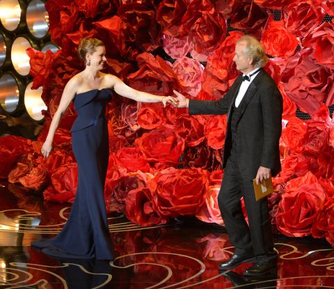 Amy Adams greets Bill Murray on stage. While reading the names of those nominated for best achievement in cinematography, Murray also mentioned director <a href="http://www.cnn.com/2014/02/24/showbiz/movies/obit-harold-ramis/index.html">Harold Ramis</a>, his "Ghostbusters" co-star who died last month at the age of 69.