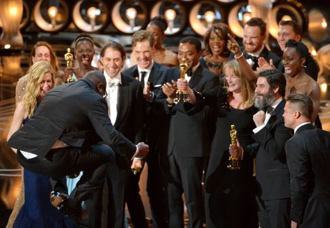 Director Steve McQueen, left, celebrates with the cast and crew of "12 Years a Slave" as they accept the Academy Award for best picture on Sunday, March 2.