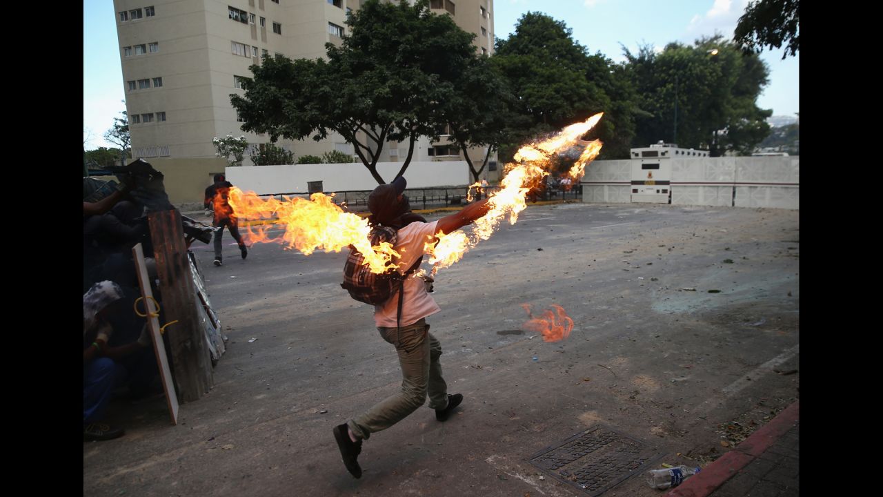 A protester hurls a Molotov cocktail at National Guard troops on March 2.