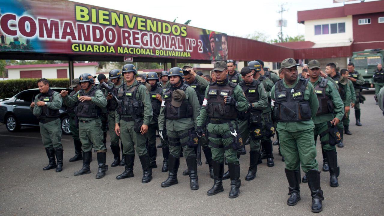 National Guard officers stand in formation after a patrol in Valencia, Venezuela, on Saturday, March 1.