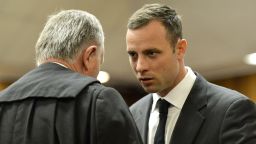 Oscar Pistorius confers with his attorney, Barry Roux, at the Pretoria High Court on March 3, 2014, in Pretoria, South Africa.