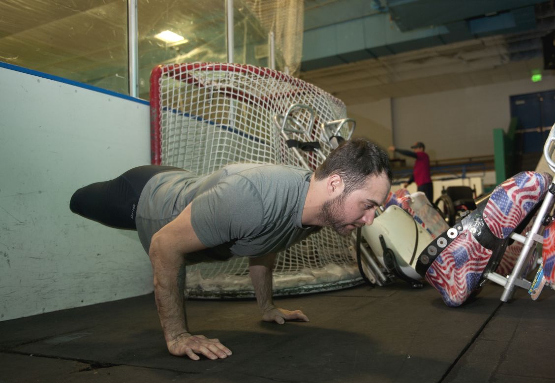 Josh Sweeney, a member of the U.S. Paralympic sled hockey team, does pushups prior to the team's final U.S.-based practice Thursday, February 27, in Colorado Springs, Colorado. The team is set to compete at the Paralympic Games in Sochi, Russia.