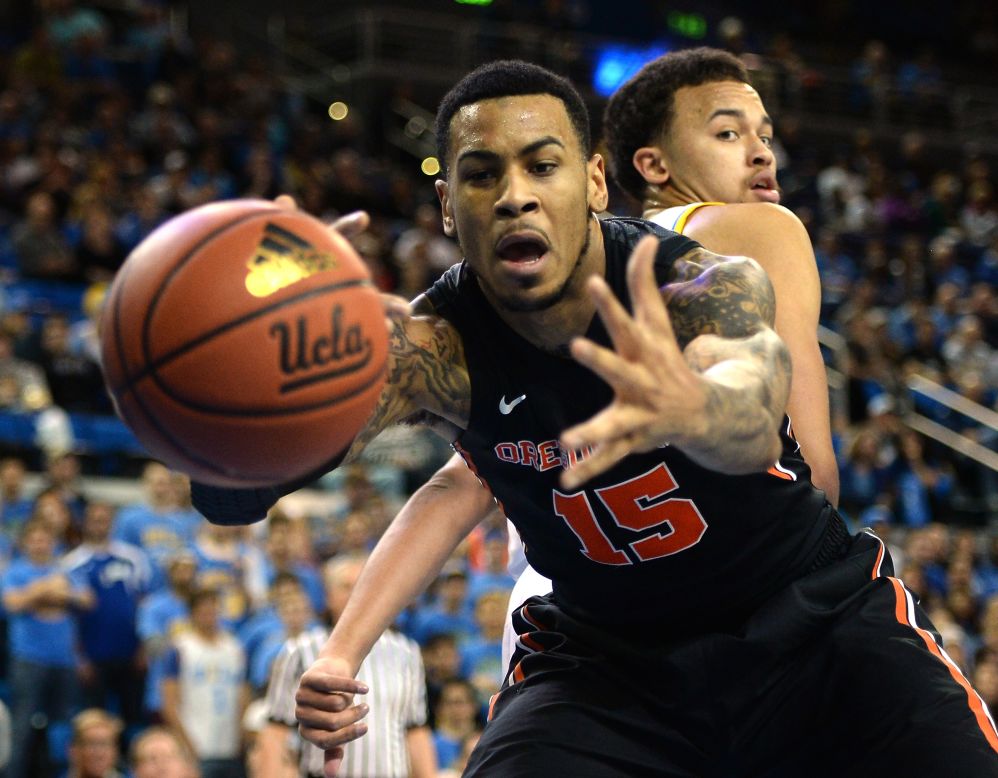 Eric Moreland of the Oregon State Beavers loses the ball as Kyle Anderson of the UCLA Bruins looks back during the first half of their game Sunday, March 2, in Los Angeles.