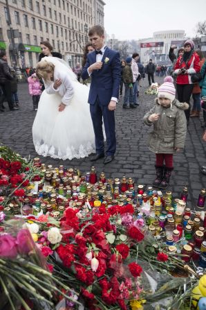 "Most weddings in Kiev now find their way to Maidan, as newlyweds come to give their gratitude and give honor to the heroes," Mikhaluk said. 