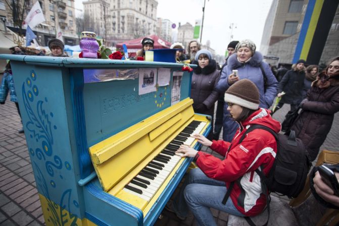 A young girl plays <a href="index.php?page=&url=http%3A%2F%2Fireport.cnn.com%2Fdocs%2FDOC-1098749">piano</a> in downtown Kiev 10 days after protests there. 