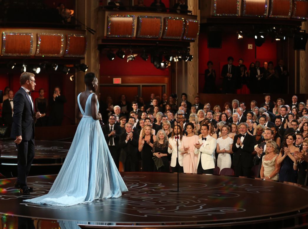 MARCH 3 - LOS ANGELES, UNITED STATES: Lupita Nyong'o receives a standing ovation as she accepts the award for best actress in a supporting role for <a href="http://cnn.com/2014/03/02/showbiz/movies/oscars-2014/index.html?hpt=hp_c3">"12 Years a Slave"</a> during the Oscars at the Dolby Theatre on March 2. The drama was named best picture at the 86th Academy Awards.