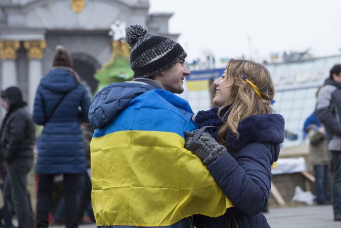 A young couple embraces in Kiev's main square where people have gathered to show their support for their country.