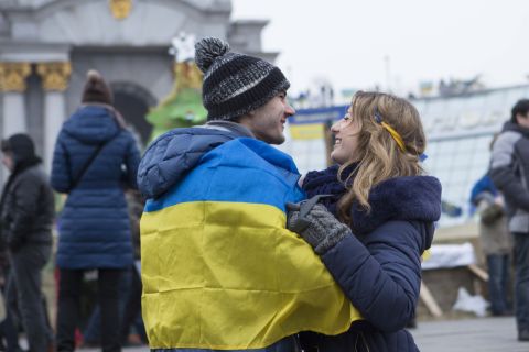A young couple embraces in Kiev's main square where people have gathered to show their support for their country.