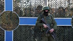 Ukrainian soldier stands behind a fence while unidentified armed men block the headquarters of the Ukrainian Navy in Sevastopol on March 3, 2014. The Russian Black Sea Fleet commander Aleksandr Vitko has issued an ultimatum to the Ukrainian military personnel in Crimea, the Interfax-Ukraine news agency reported. Ukraine accused Russia on Monday of pouring more troops into Crimea as world leaders grappled with Europe's worst standoff since the Cold War and the Moscow market plunged on fears of an all-out conflict. AFP PHOTO/ VIKTOR DRACHEV (Photo credit should read VIKTOR DRACHEV/AFP/Getty Images)