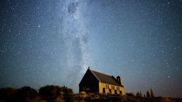 Next to Lake Tekapo, looking south, you can see the Milky Way stretching over the Church of the Good Shepherd. The Southern Cross and the Coal Sack Nebula are visible near the top.