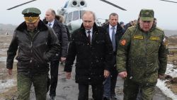 Russian President Vladimir Putin, center, and Defense Minister Sergei Shoigu, left, and the commander of the Western Military District Anatoly Sidorov, right, walk upon arrival to watch military exercise near St.Petersburg, Russia, Monday, March 3, 2014. Putin has sought and quickly got the Russian parliament's permission to use the Russian military in Ukraine.(AP Photo/RIA-Novosti, Mikhail Klimentyev, Presidential Press Service)