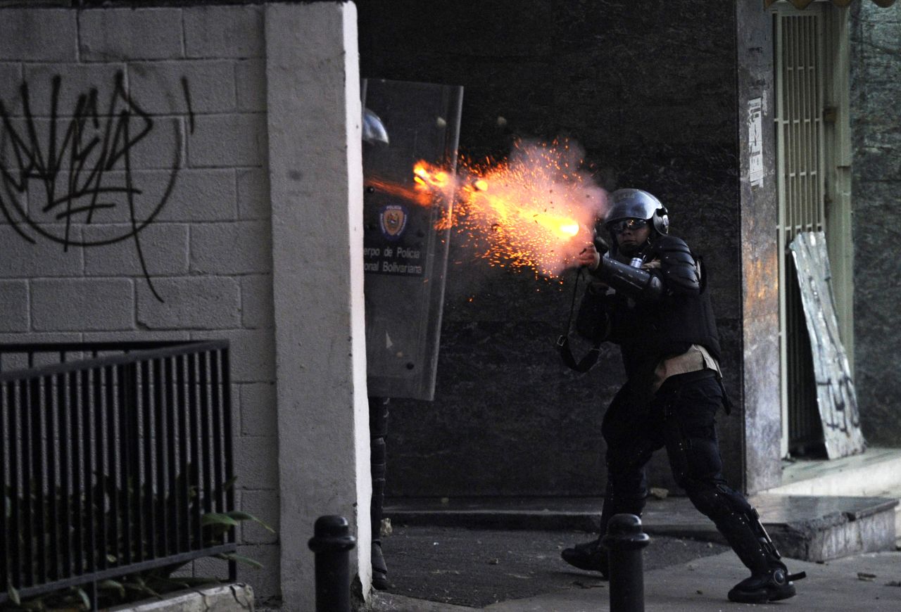 A National Guard member shoots tear gas during protests in Caracas on March 3.