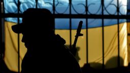 The silhouette of a Ukrainian soldier is seen against a Ukrainian flag as Ukrainian soldiers wait inside the Sevastopol tactical military brigade base in Sevastopol on March 3, 2014. Russian forces have given Ukrainian soldiers an ultimatum to surrender their positions in Crimea or face an assault, a Ukrainian defence ministry spokesman said. 'The ultimatum is to recognise the new Crimean authorities, lay down our weapons and leave, or be ready for an assault,' said Vladyslav Seleznyov, the regional ministry spokesman for the Crimea. AFP PHOTO / FILIPPO MONTEFORTE (Photo credit should read FILIPPO MONTEFORTE/AFP/Getty Images)