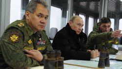 Russia's President Vladimir Putin (C) listens to the head of the Russian army's main department of combat preparation Ivan Buvaltsev (R) while watching military exercises at the Kirillovsky firing ground in the Leningrad region, on March 3, 2014, with  Defence Minister Sergei Shoigu (L)attending. Crimea, the strategic host to tsarist and Kremlin navies since the 18th century, has been under de facto occupation by Moscow-backed forces since Putin won recently parliament's authorisation to send troops into Ukraine. AFP PHOTO/ RIA-NOVOSTI/ POOL/ MIKHAIL KLIMENTYEV        (Photo credit should read MIKHAIL KLIMENTYEV/AFP/Getty Images)