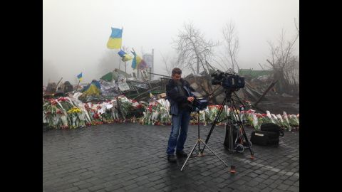 KIEV, UKRAINE:  CNN Cameraman Christian Streib sets up for live shots by the barricades on the road to Independence Square on March 4.  Photo by CNN's Jon Steward.  