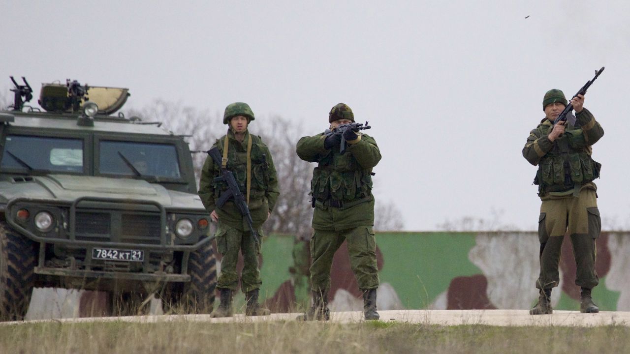 Russian soldiers fire warning shots to keep back Ukrainian military members at the Belbek air base on March 4.