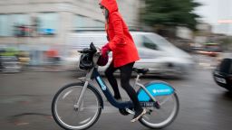 A cyclist rides on a Boris Bike in central London on November 20, 2013. 