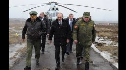Russia's President Vladimir Putin, center, and Defense Minister Sergei Shoigu, left, arrives to watch a military exercise at the Kirillovsky firing ground in the Leningrad region, on March 3, 2014.