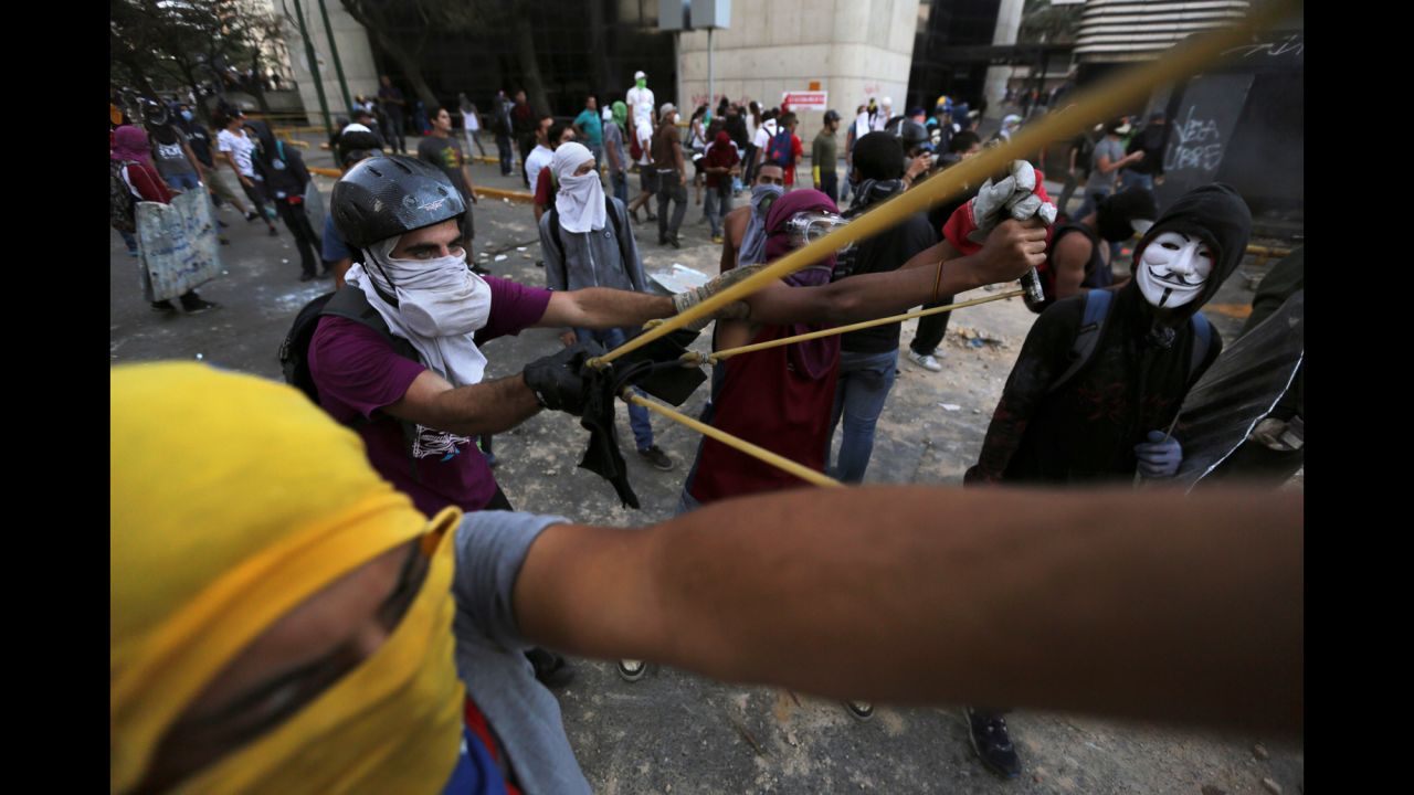 Protesters use a giant slingshot to launch stones at police during clashes in Caracas on Monday, March 3.