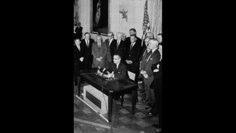 President Lyndon B. Johnson signs the Gulf of Tonkin Resolution in August 1964. The resolution, approved by Congress, gave Johnson power to send U.S. troops to South Vietnam after it was alleged that North Vietnamese patrol boats had fired on the USS Maddox in the Gulf of Tonkin. 