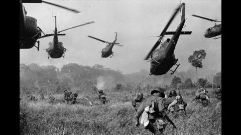 Hovering U.S. Army helicopters pour machine gun fire into the tree line to cover the advance of South Vietnamese ground troops in an attack on a Viet Cong camp northwest of Saigon, near the Cambodian border, in March 1965. The Vietnam War lasted nearly a decade and left more than 58,000 Americans dead.