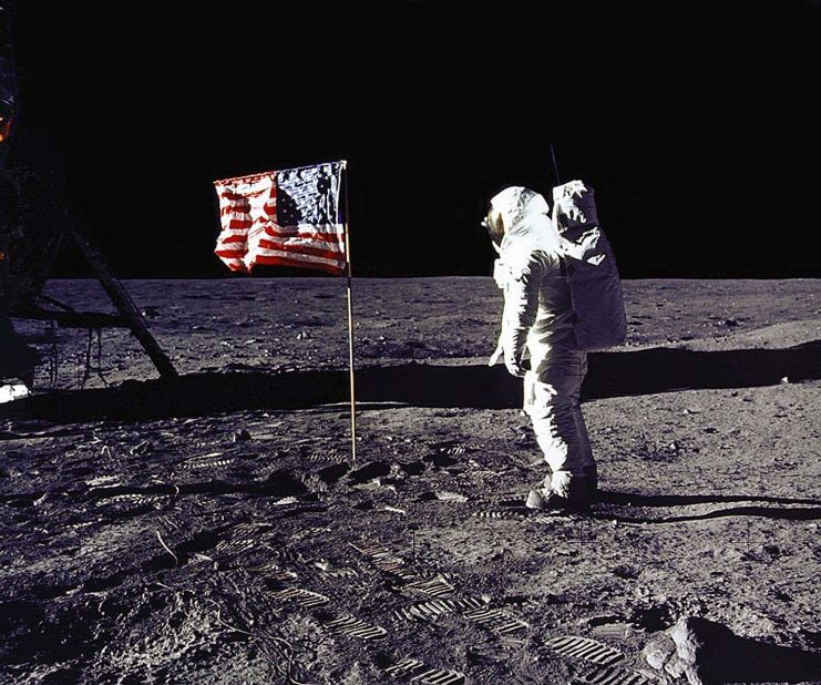 Apollo 11 astronaut Edwin E. "Buzz" Aldrin Jr. salutes the U.S. flag on the lunar surface on July 20, 1969. He and mission commander Neil Armstrong became the first humans to walk on the moon. Their mission was considered an American victory in the Cold War and subsequent space race, meeting President Kennedy's goal, voiced in 1961, of "landing a man on the moon and returning him safely to the earth" before the end of the decade.
