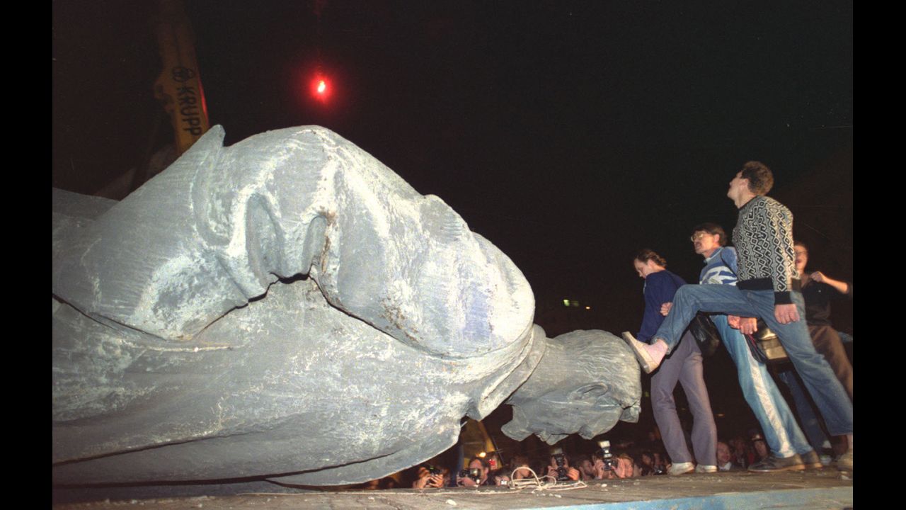 Jubilant people step on the head of the statue of Felix Dzerzhinsky, the founder and chief of the Soviet secret police, later known as KGB, which was toppled in front of the KGB headquarters in Moscow, on August 23, 1991. The KGB was responsible for mass arrests and executions. 