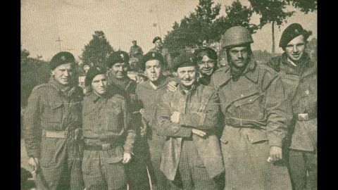 Dionizy Storozynski, wearing a helmet, poses with members of his regiment -- the Polish 24 Lancers -- during the invasion of Normandy, near Abbeville, France. <br />He was a motorcycle scout.