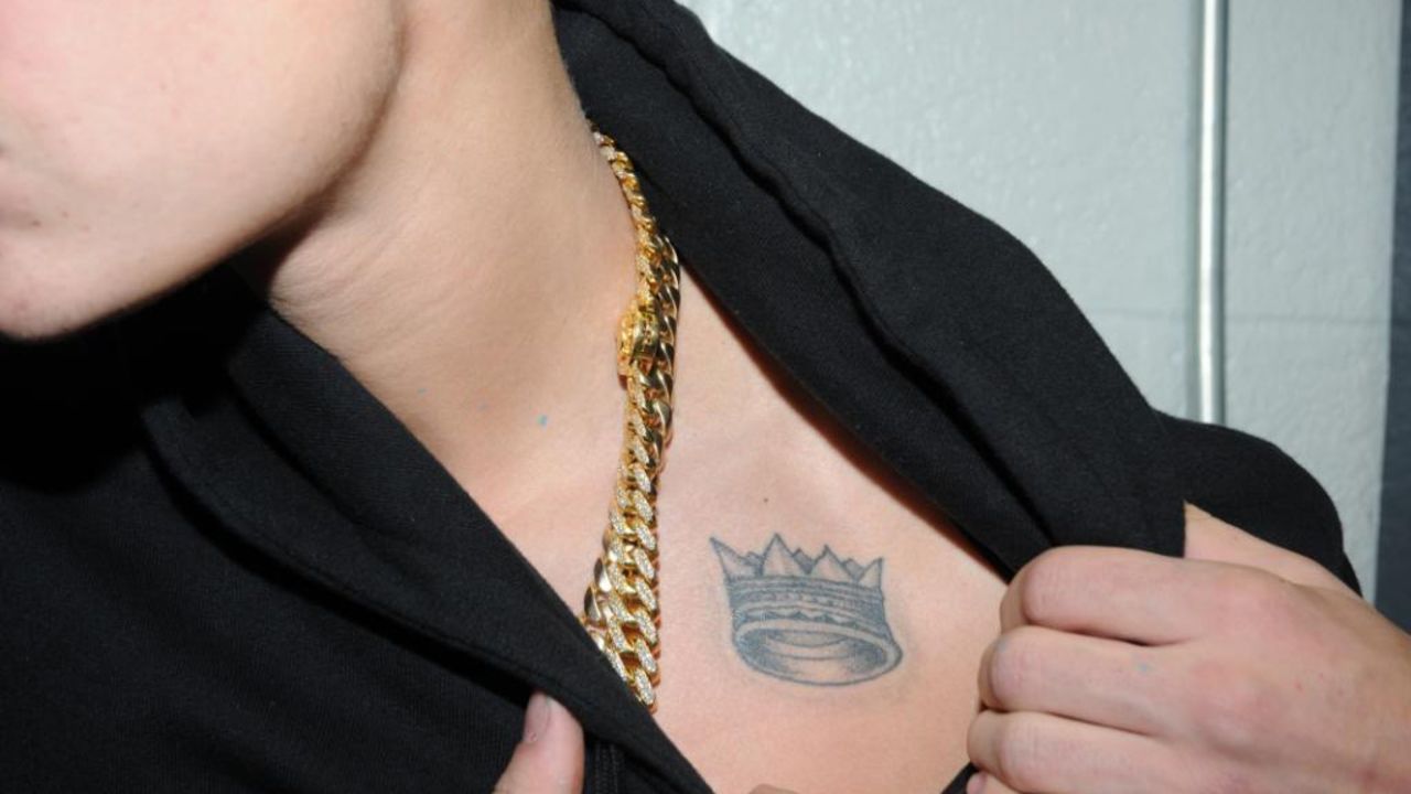 The singer sports a crown tat high on his chest. 