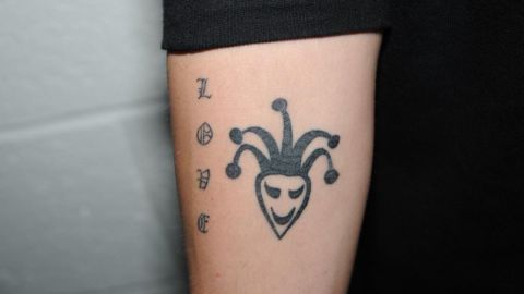 Bieber displays the world "love" and a Joker symbol on his arm.