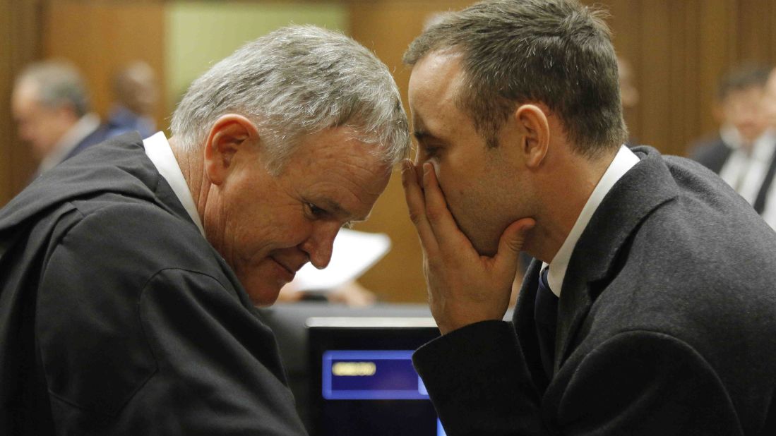 Pistorius talks with Roux inside the court on March 4.