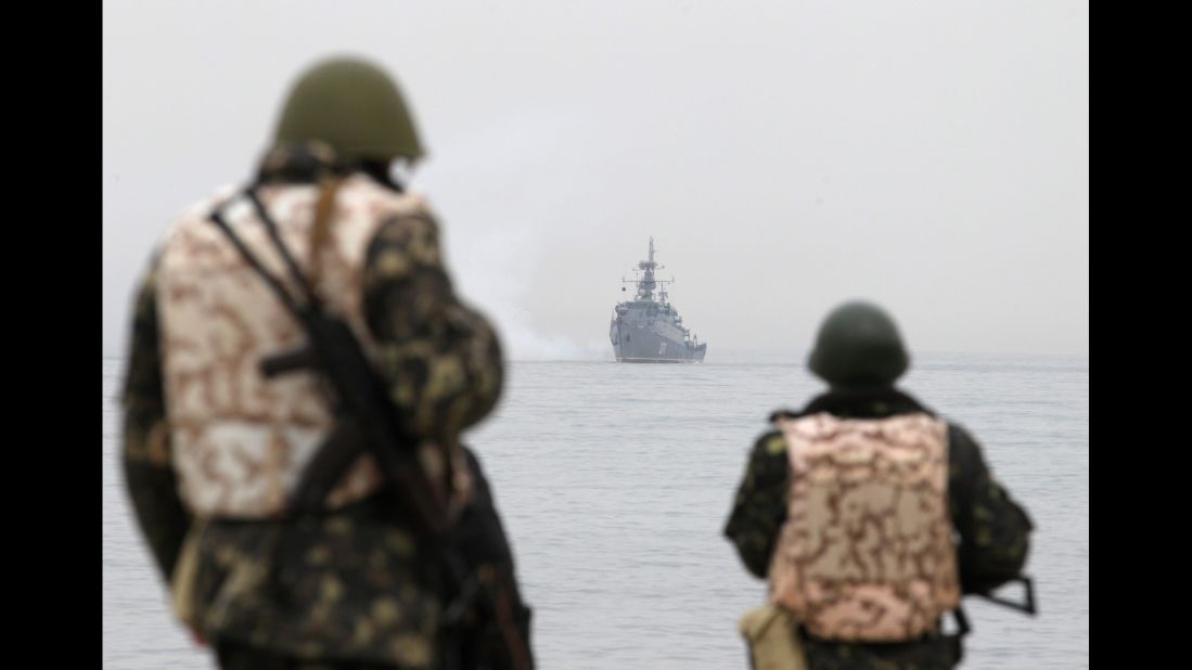 Ukrainian troops watch as a Russian navy ship blocks the entrance of the Ukrainian navy base in Sevastopol on March 4.