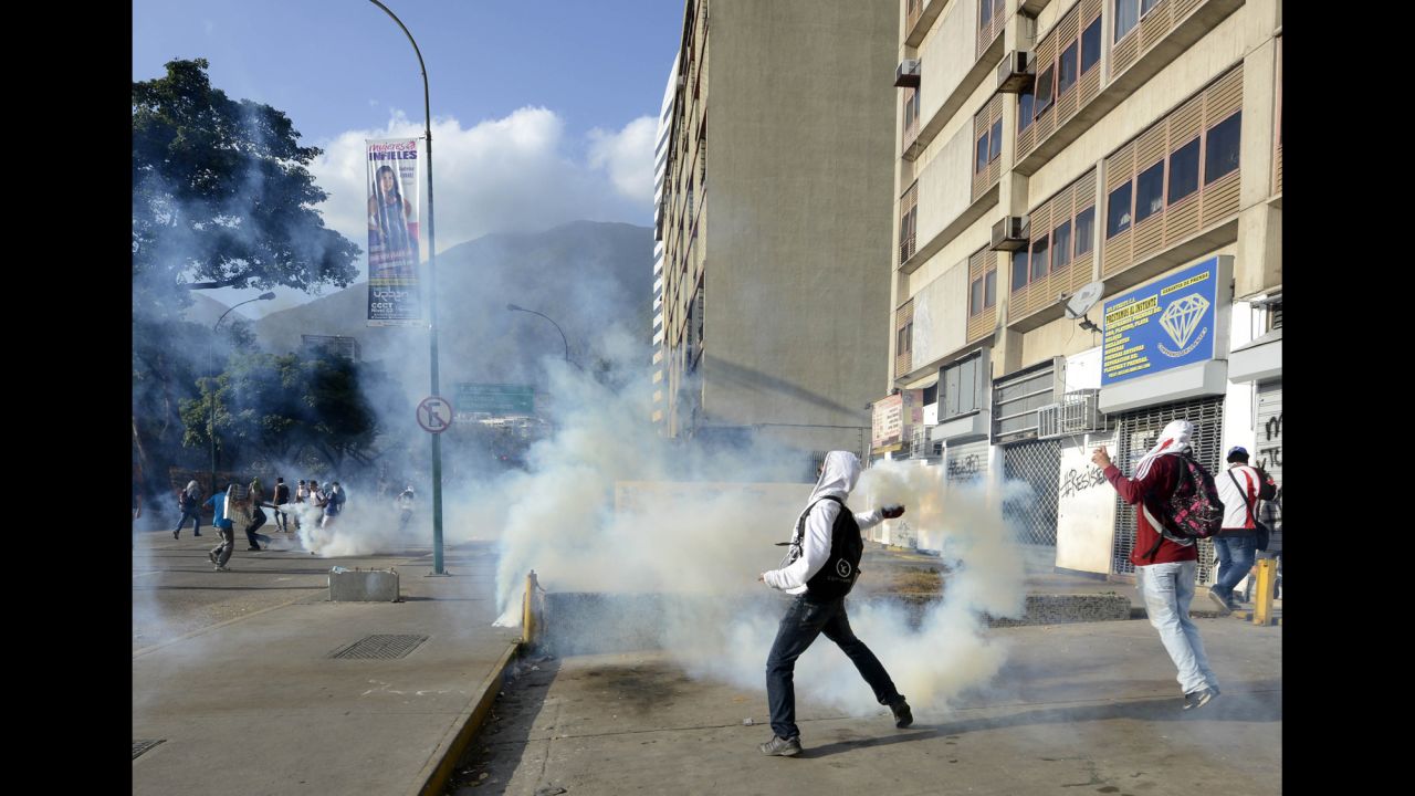 A protester throws a tear gas canister toward National Guard members in Caracas on March 4.