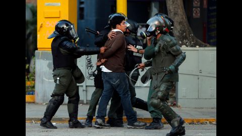 National Guard members detain a protester March 4 in Caracas.