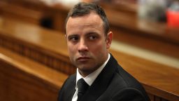 South African Paralympic athlete Oscar Pistorius, accused of murdering his girlfriend Reeva Steenkamp waits prior to a hearing of his trial at the North Gauteng High Court in Pretoria, on March 5, 2014.