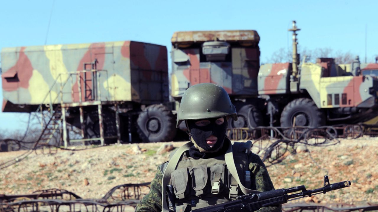 A Russian service member guards an anti-aircraft missile unit in Sevastopol, Ukraine, in March 2014. Five recent deaths have heightened suspicions on both side of Ukraine's ethnic divide.